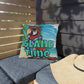 Decorative pillow with a parrot design and 'Island Time' text on a patio setting.