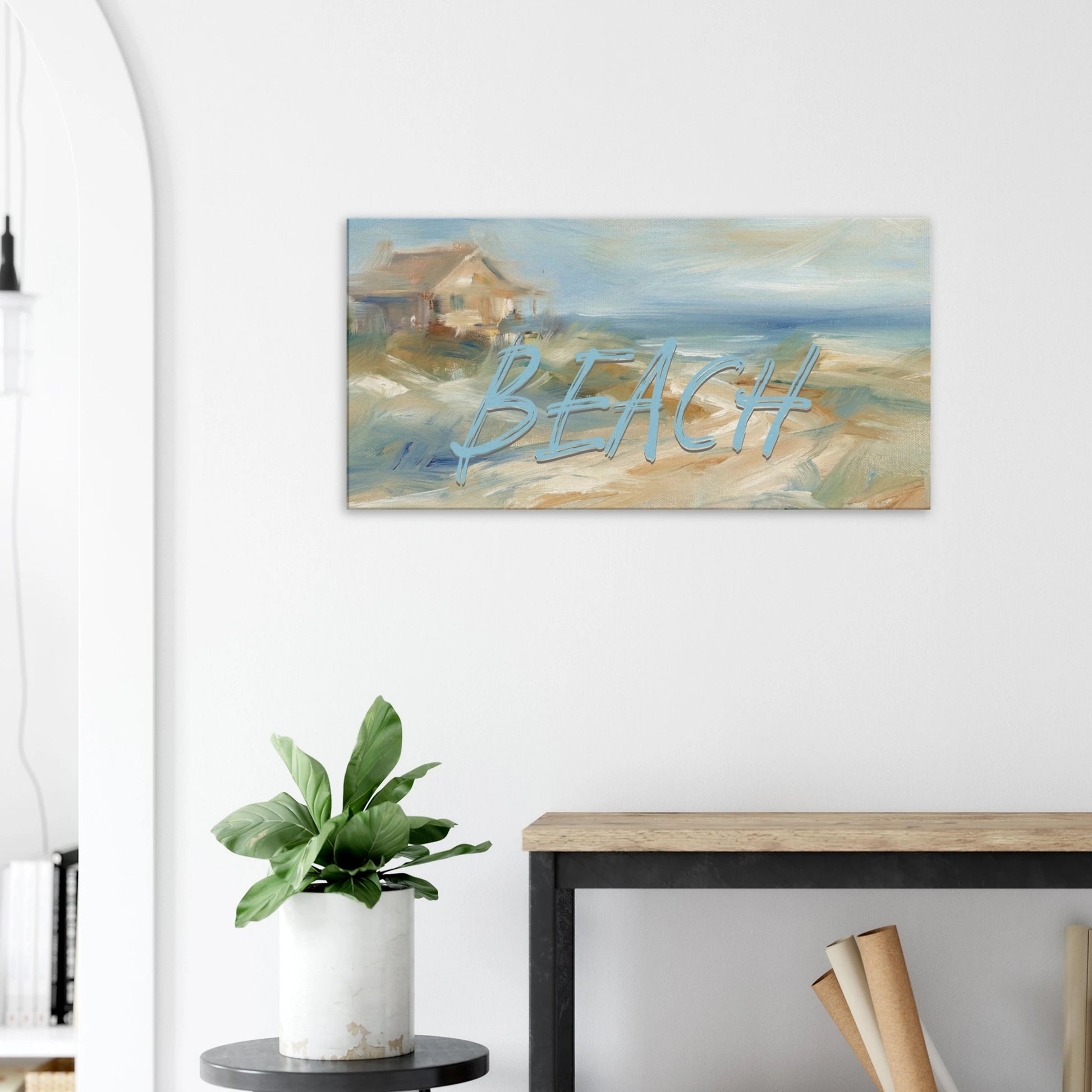 Beach-themed wall art with 'BEACH' text in a room with a plant and desk.