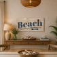Nautical-themed room with 'Beach' sign, lamp, and decor.