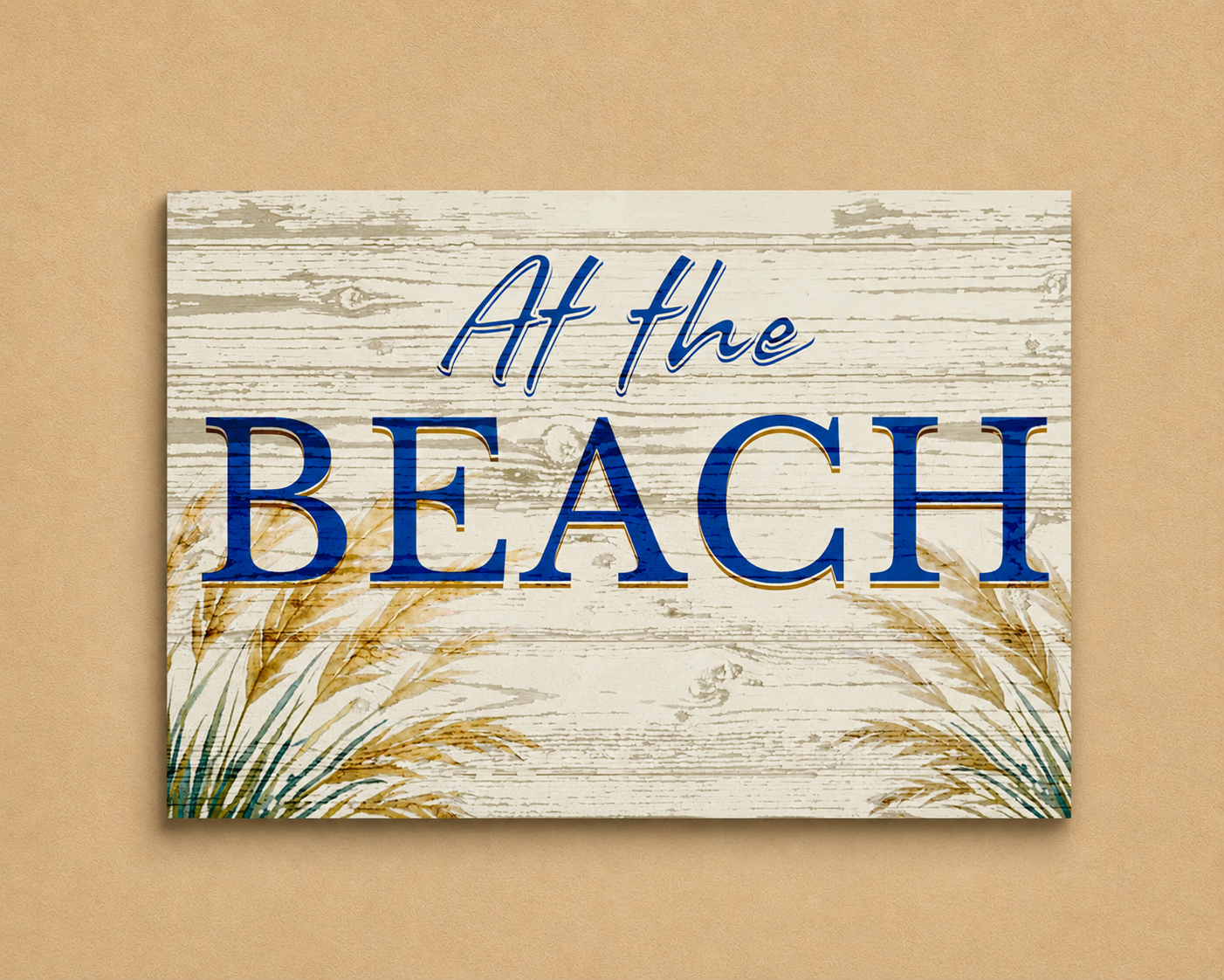 Decorative sign with 'At the Beach' text on a wooden background