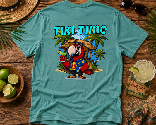 Teal t-shirt with a parrot graphic and 'Tiki Time' text on a wooden surface with tropical items.