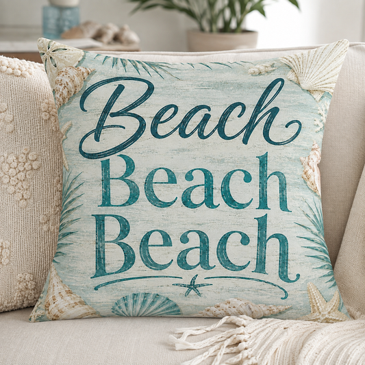 Square decorative pillow with teal "Beach" lettering on aqua shell-and-starfish printed fabric