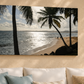 Beach scene with palm trees on a wall above a sofa