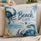 Square pillow with 'Beach Life' text and blue crab, fish, and starfish illustrations