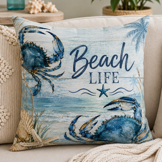 Square pillow with 'Beach Life' text and blue crab, fish, and starfish illustrations