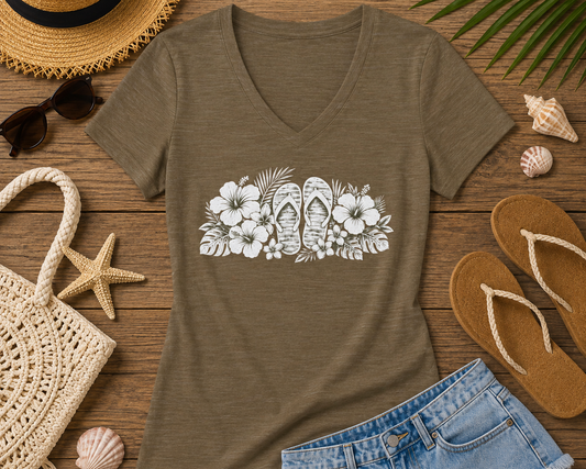 A women's short-sleeve V-neck t-shirt in heathered brown, featuring a white graphic print of tropical flowers and flip-flops across the chest, displayed on a clean white background.