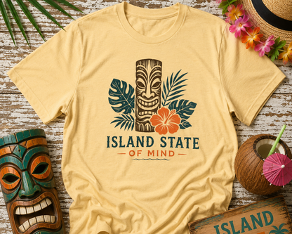 Beige t-shirt with 'Island State of Mind' design on a wooden surface with tropical decor.