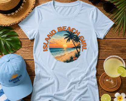 Light blue t-shirt with 'Island Beach Girl' design on a wooden surface with beach accessories.