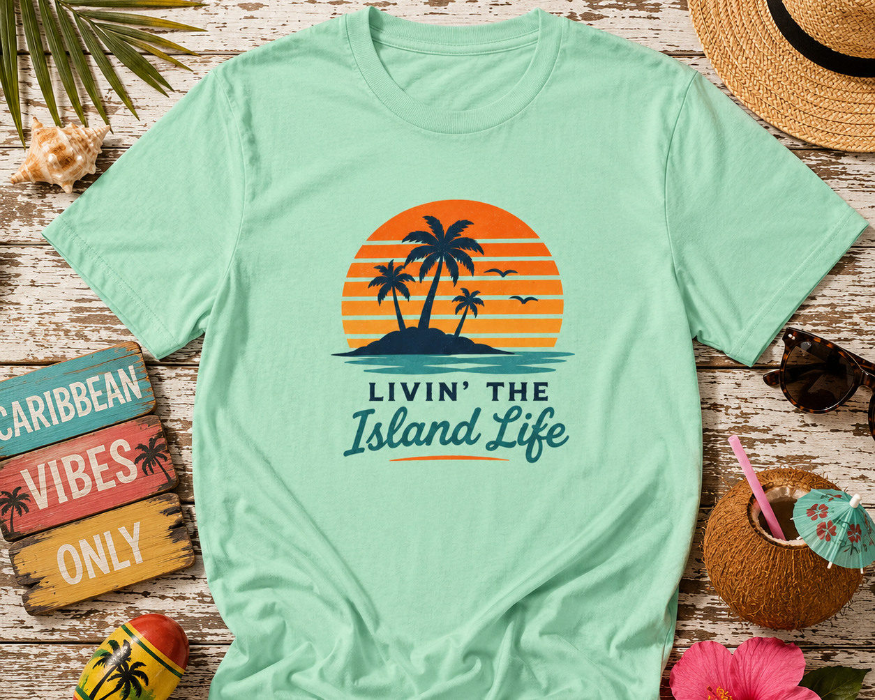 Mint green t-shirt with 'Livin' the Island Life' design on a wooden surface with tropical accessories.