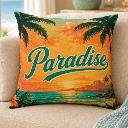 A square decorative throw pillow with a tropical sunset design and the word 'Paradise' in teal script, resting on a beige sofa in a bright living room.