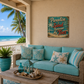Turquoise outdoor sofa with decorative pillows on a patio with a beach view and 'Paradise is Sand Between My Toes' sign.
