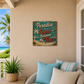 Decorative sign with 'Paradise is Sand Between My Toes' on a wall with a beach view.
