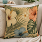 Tropical leaves square pillow on a sofa cushion, beige flowers with green and blue leaves