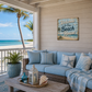 Cozy outdoor living space with a beach house sign, couch, and ocean view.