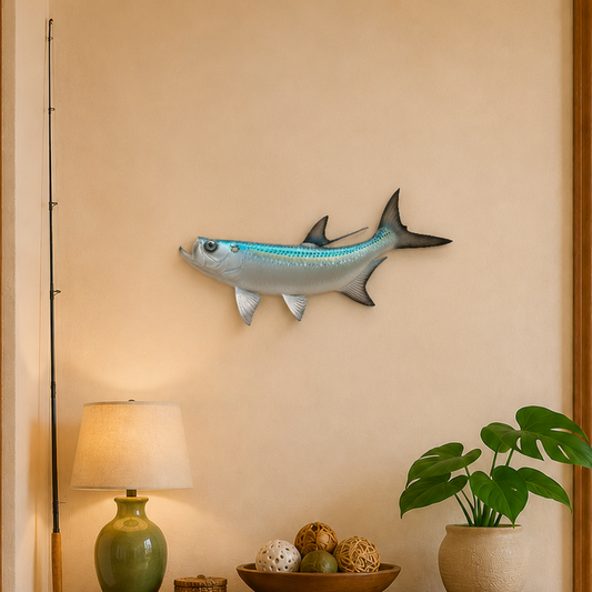 Decorative fish wall art above a wooden console table with a lamp, books, and plant.