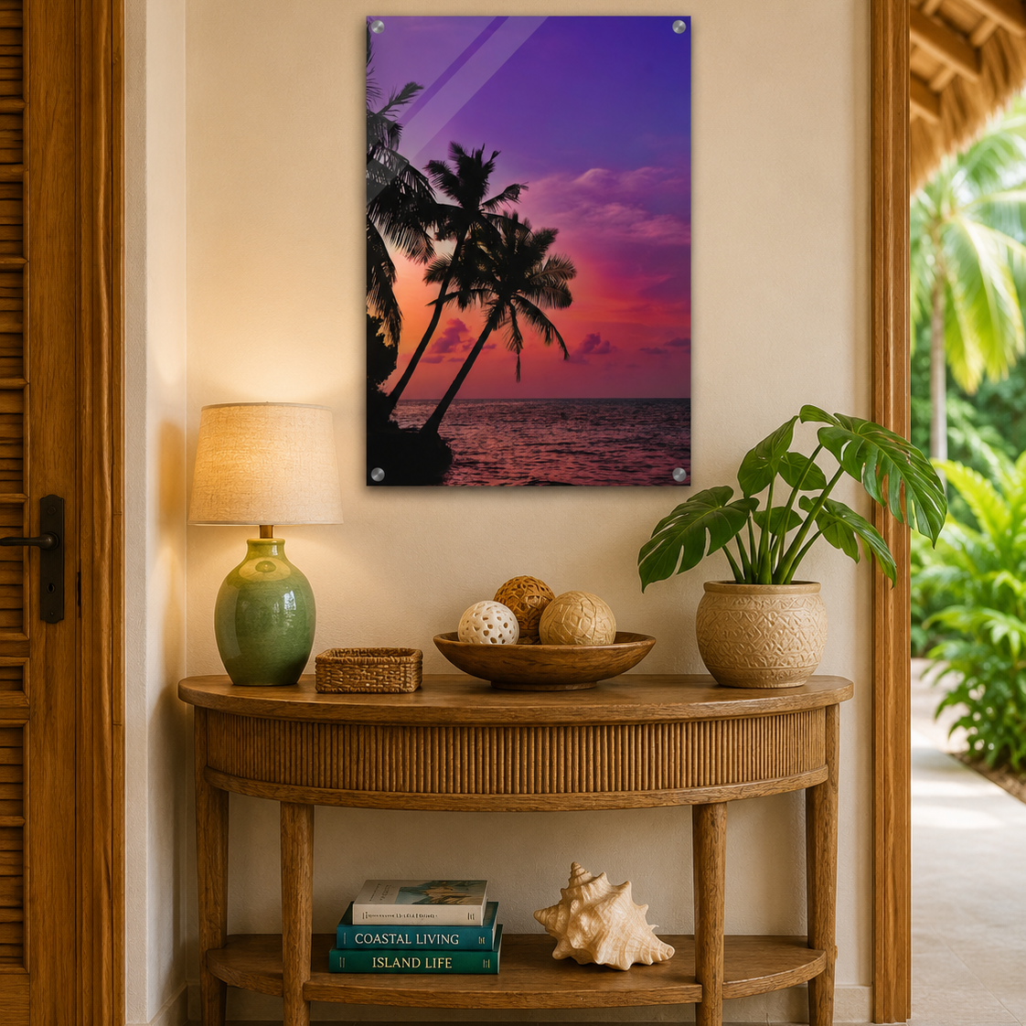 Decorative wall art of palm trees and sunset over a table with decor items.