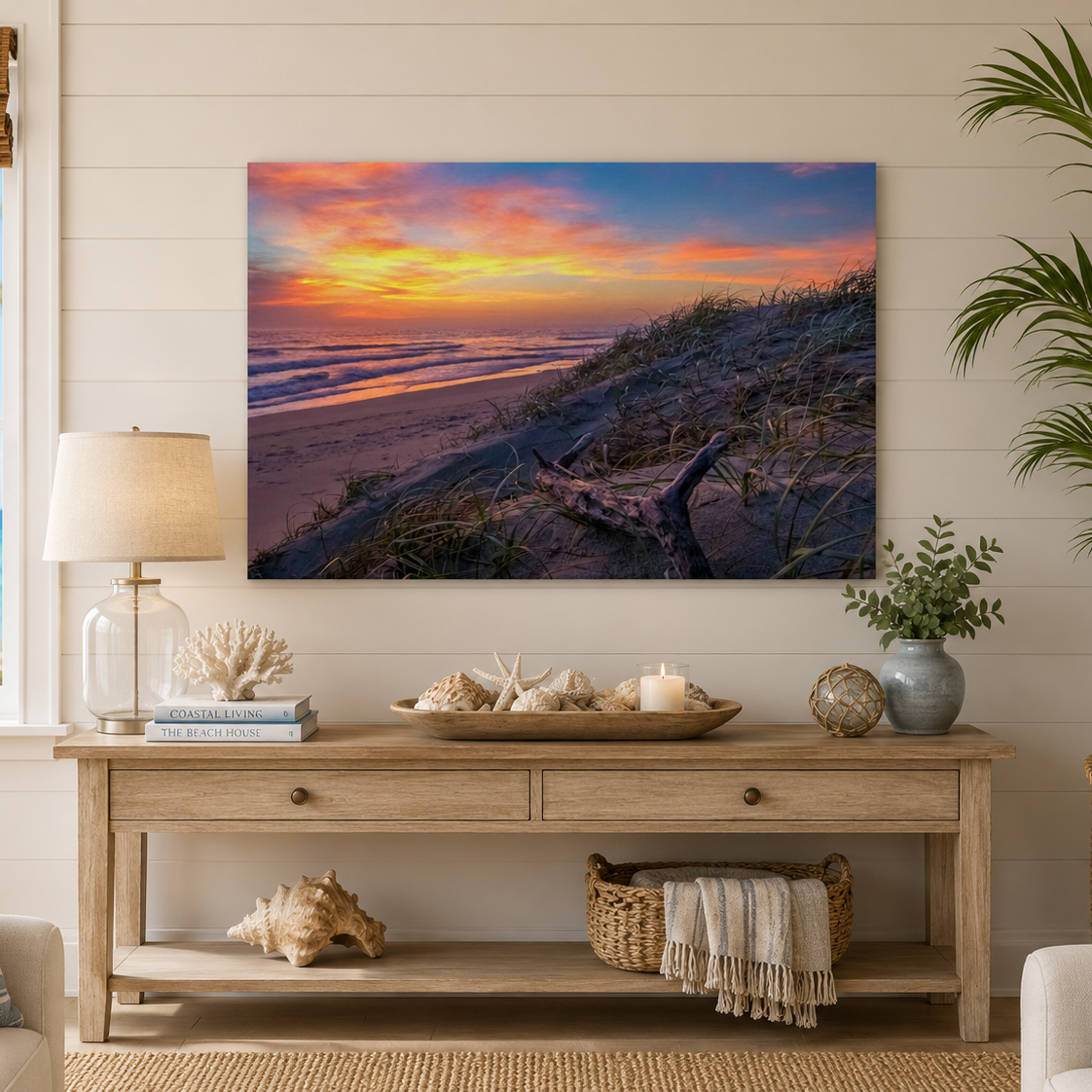 Living room with a large beach sunset painting on the wall, wooden console table, and decorative items.