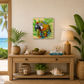 Decorative interior with a wooden console table, plants, and a colorful parrot painting.