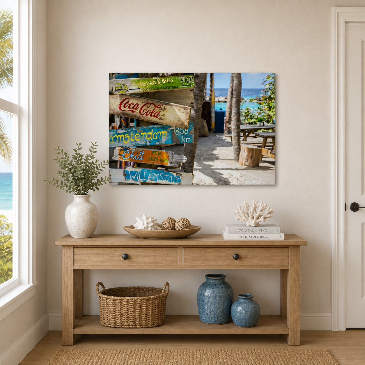 Room interior with a wooden console table, decorative items, and a large wall art of a beach scene.
