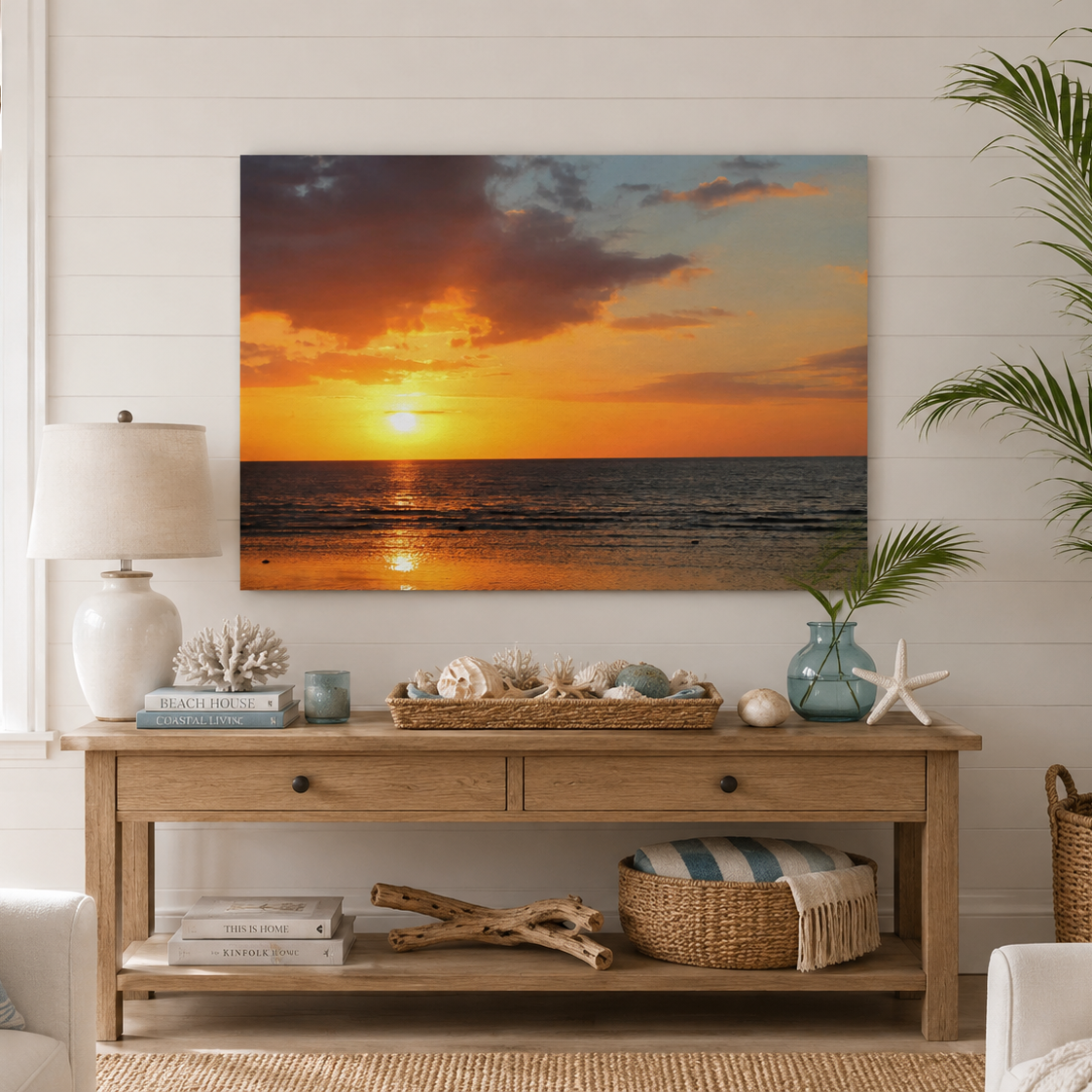 Living room with a large sunset over ocean painting on the wall, wooden console table, and decorative items.