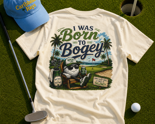 T-shirt with 'I Was Born to Bogey' design, blue cap, golf club, and ball on grass