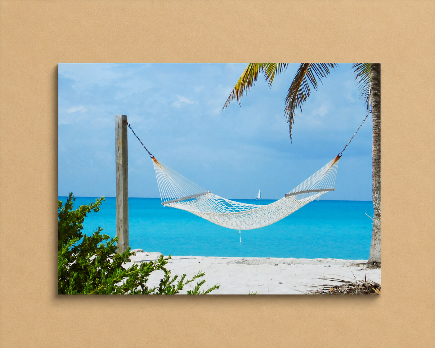 Hammock between two palm trees with a clear blue sky and ocean in the background