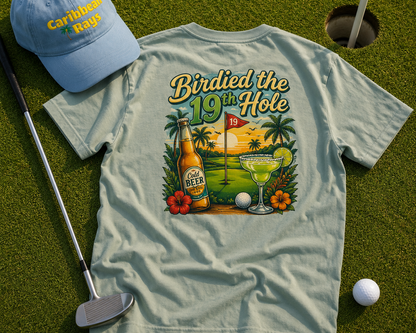 T-shirt with 'Birdied the 19th Hole' design on a golf course, featuring a cap and golf club.