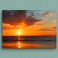 Sunset over water with orange and purple hues on a light blue background