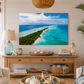 Living room with a large wall art of a tropical beach scene, wooden console table, and decorative items.