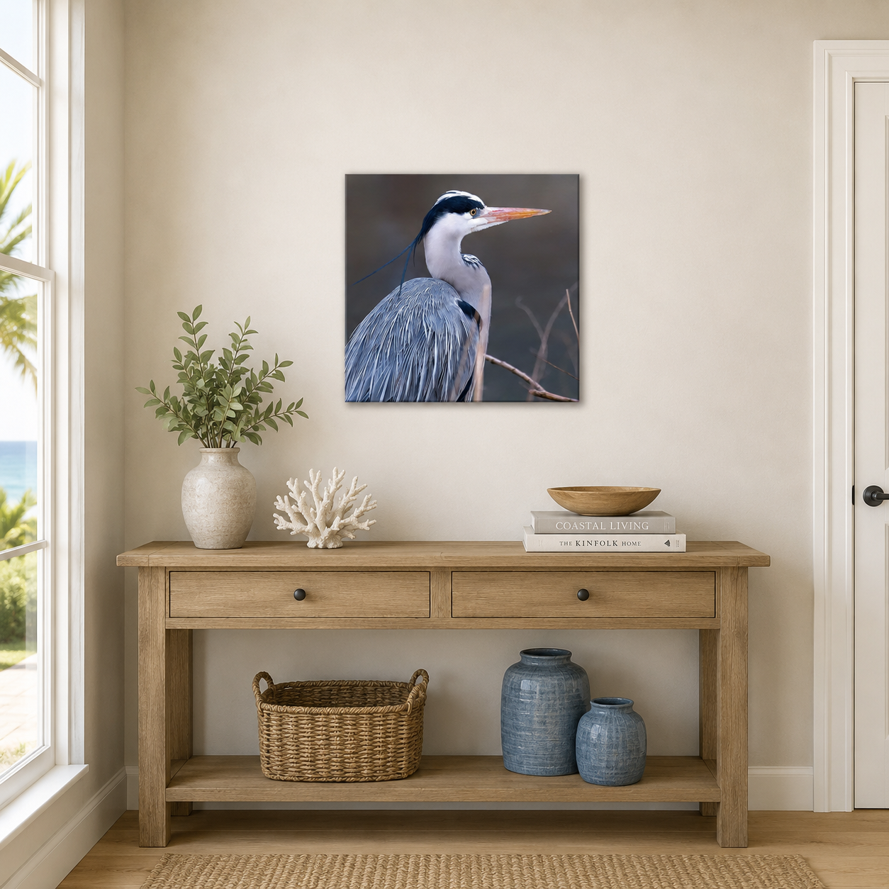 Wooden console table with decorative items against a wall with a heron painting.