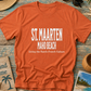 Orange t-shirt with 'St. Maarten Maho Beach' text on a wooden surface with beach-themed items.