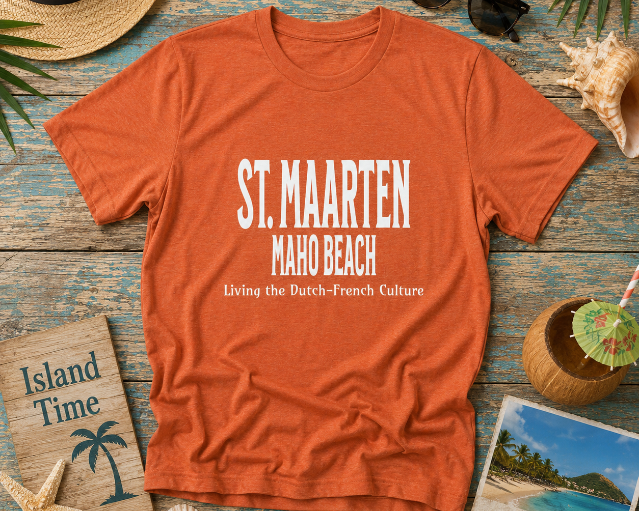 Orange t-shirt with 'St. Maarten Maho Beach' text on a wooden surface with beach-themed items.
