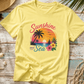 Yellow t-shirt with 'Sunshine and Sea' design on a wooden surface with beach-themed accessories.