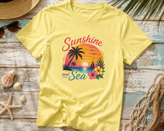 Yellow t-shirt with 'Sunshine and Sea' design on a wooden surface with beach-themed accessories.